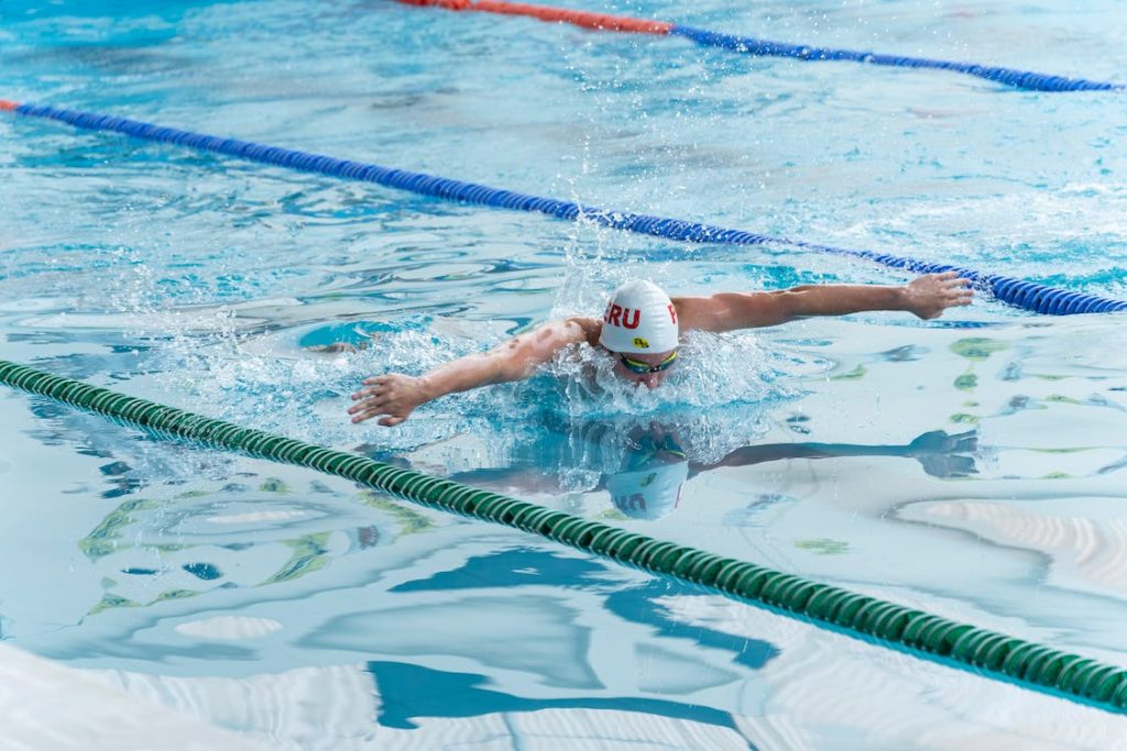 male swimmer swimming in indoor pool