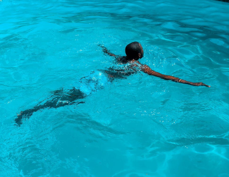 african swimming in a blue serene swimming pool 