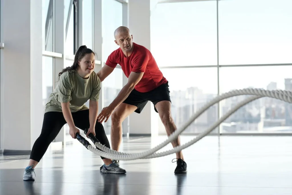 female swimmer exercising with battle ropes