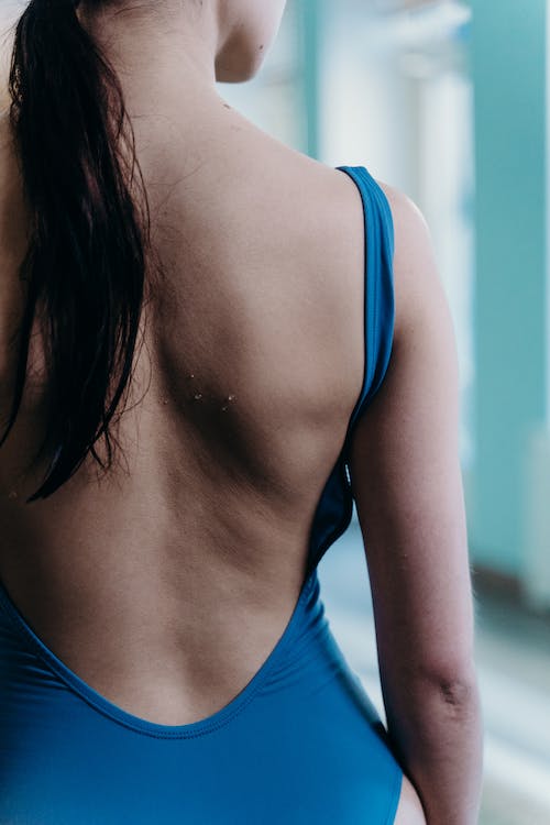 the female swimmer's body type with lean muscle mass, and broad shoulders