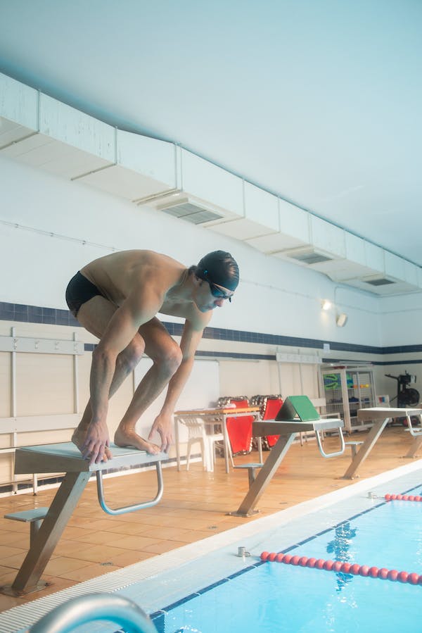 male swimmer performing starts from various positions on the block